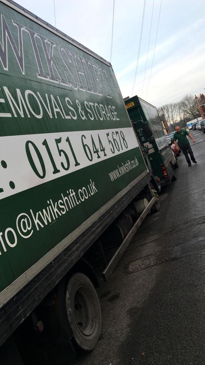 Kwikshift crew member beside a removal lorry