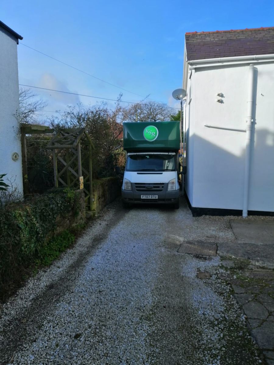 Kwikshift van reversed up a narrow driveway